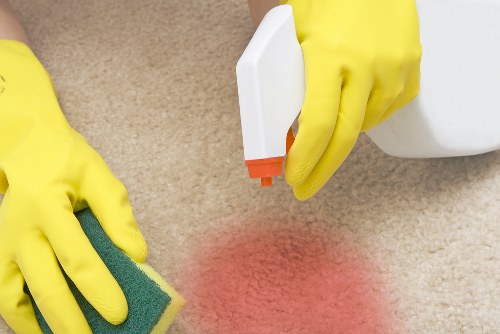 Professional home cleaner working in a Chiswick living room